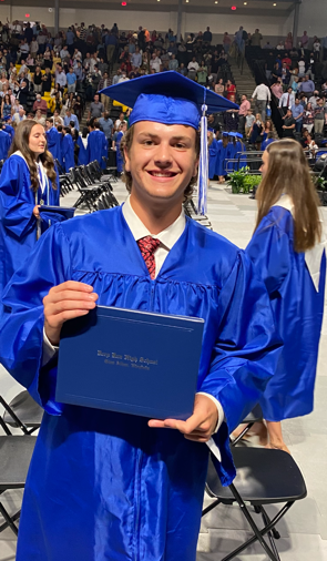 Photo of Nate with his high school diploma
